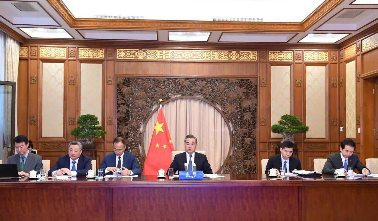 Chinese State Councilor and Foreign Minister Wang Yi holds a video conference with Iranian Foreign Minister Mohammad Javad Zarif in Beijing. Photo: Xinhua