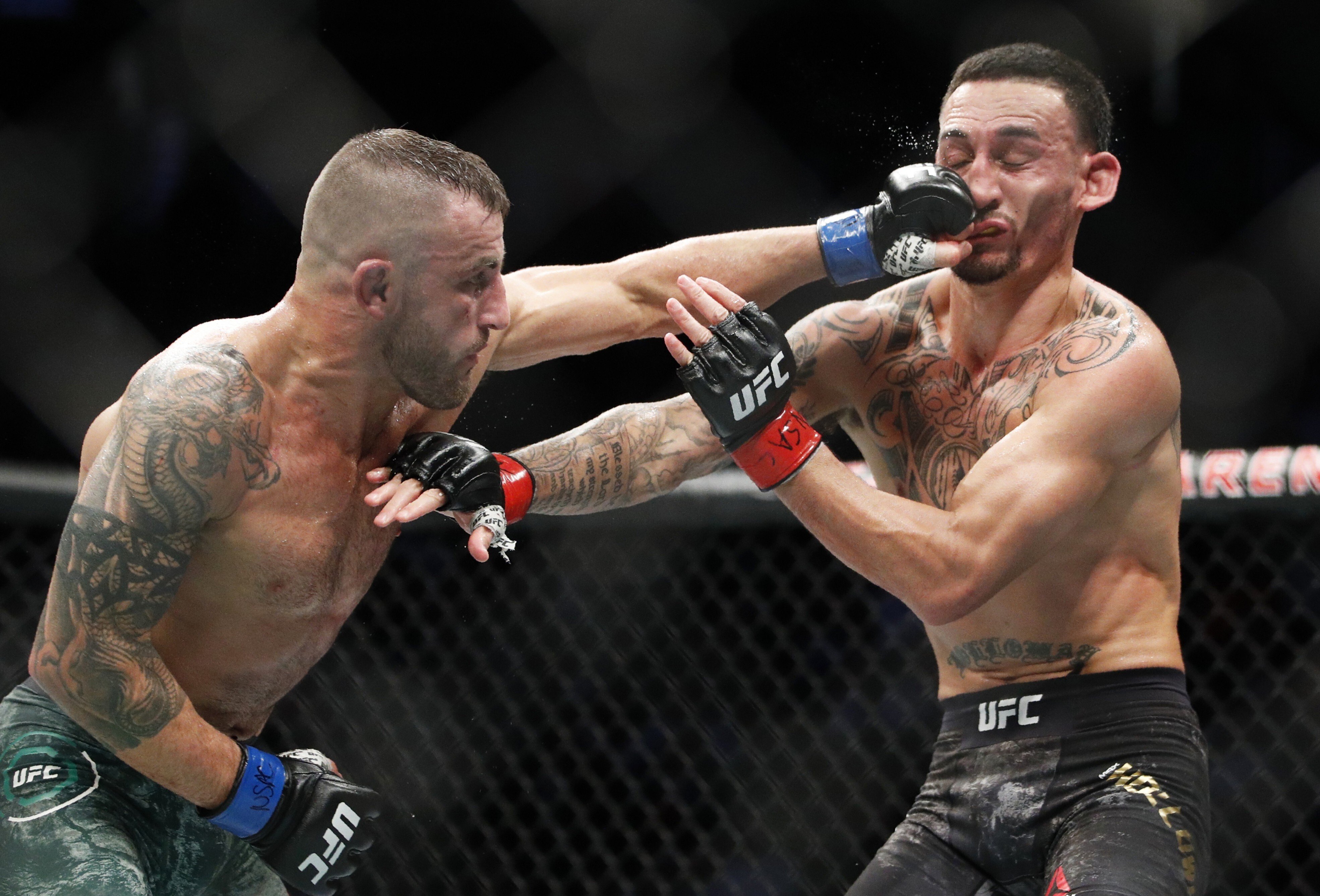 UFC featherweight champion Alexander Volkanovski hits Max Holloway in their featherweight title bout at UFC 245 in Las Vegas, Nevada, in December 2019. Photo: AP