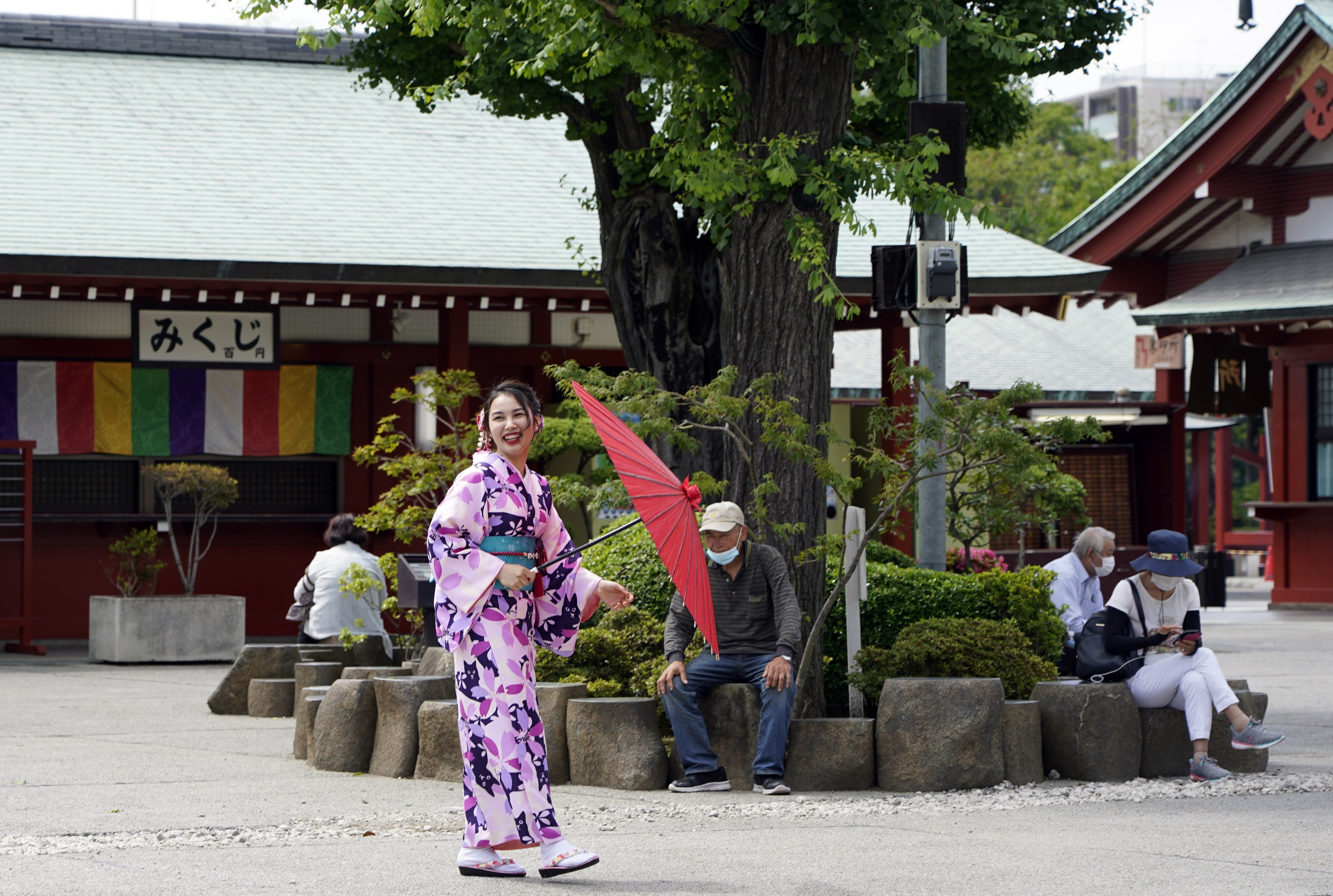 A kimono-clad tourist and others visit the Sensoji temple in the Asakusa district of Tokyo, Japan, on June 24. As tourist arrivals are unlikely to pick up in the short term, capacity in the hospitality sector will remain underutilised for some time. Photo: EPA-EFE