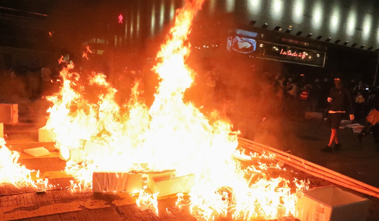 Anti-government protesters set fire to objects on Nathan Road, Mong Kok in February. The months-long civil unrest was sparked last June by the now-withdrawn extradition bill. Photo: Felix Wong