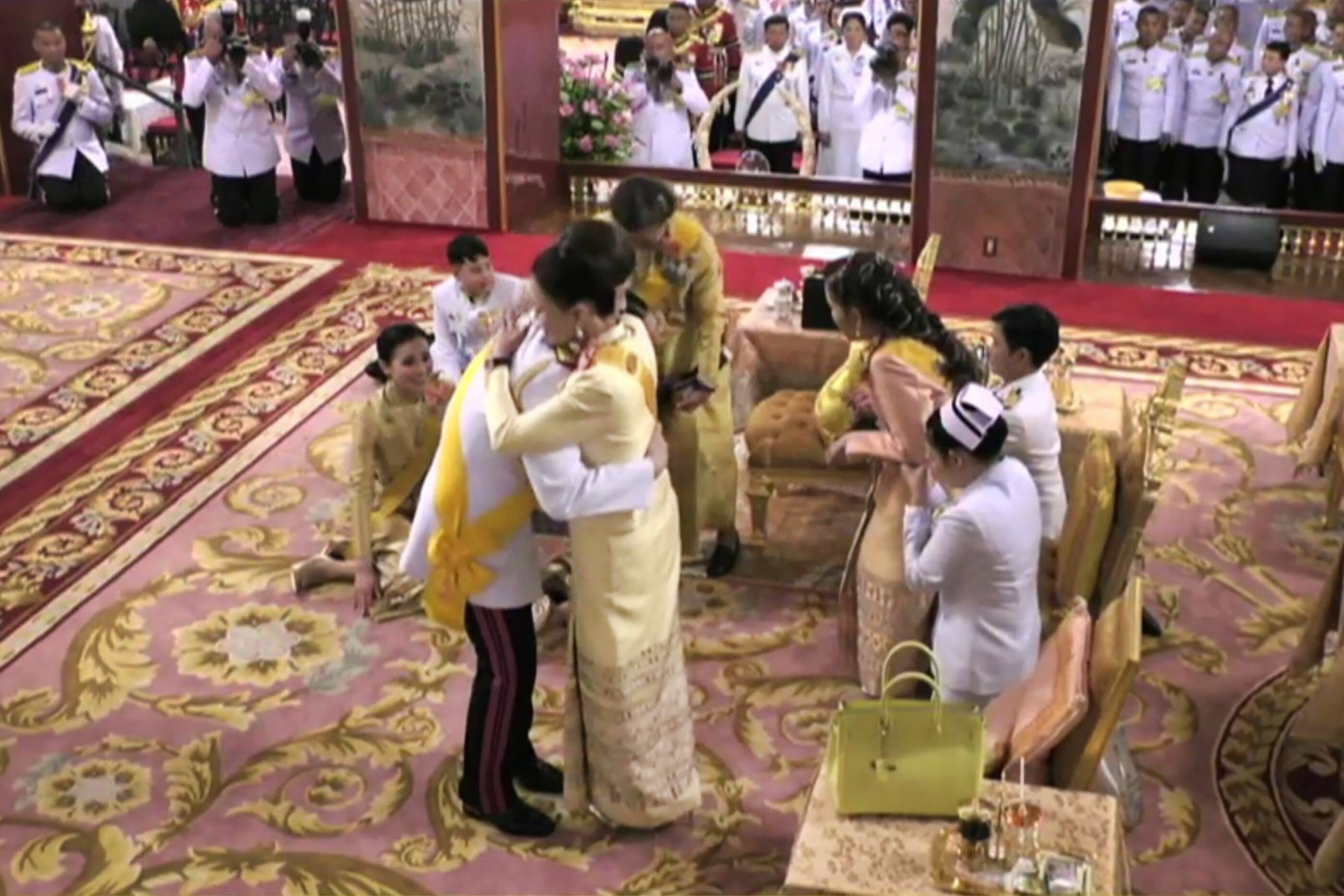 Thailand’s King Maha Vajiralongkorn hugs his sister Princess Ubolratana – whose candidacy as prime minister he previously blocked – during his coronation in May 2019. Photo: AFP