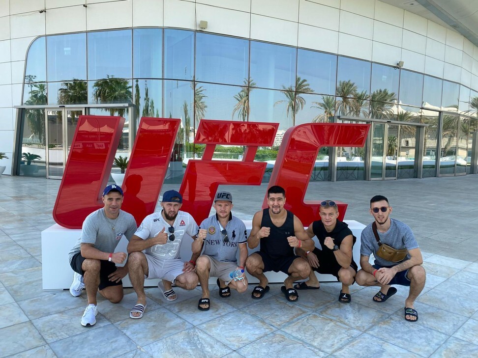 Petr Yan and his team pose for a photo in Abu Dhabi. Photo: @johnboyboxing