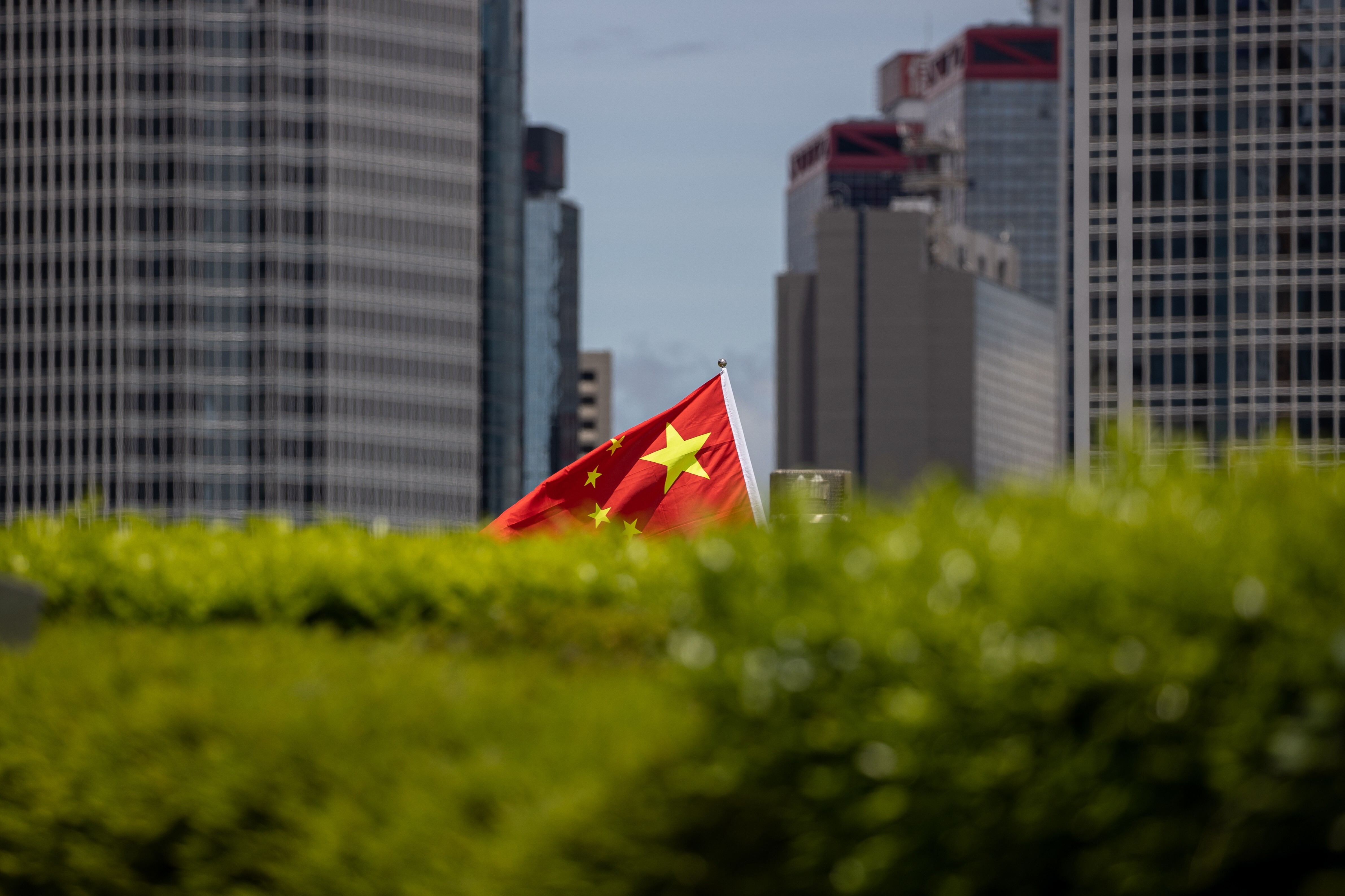 A Chinese flag is held aloft during a rally in Hong Kong in support of the national security law on June 30. Photo: EPA-EFE