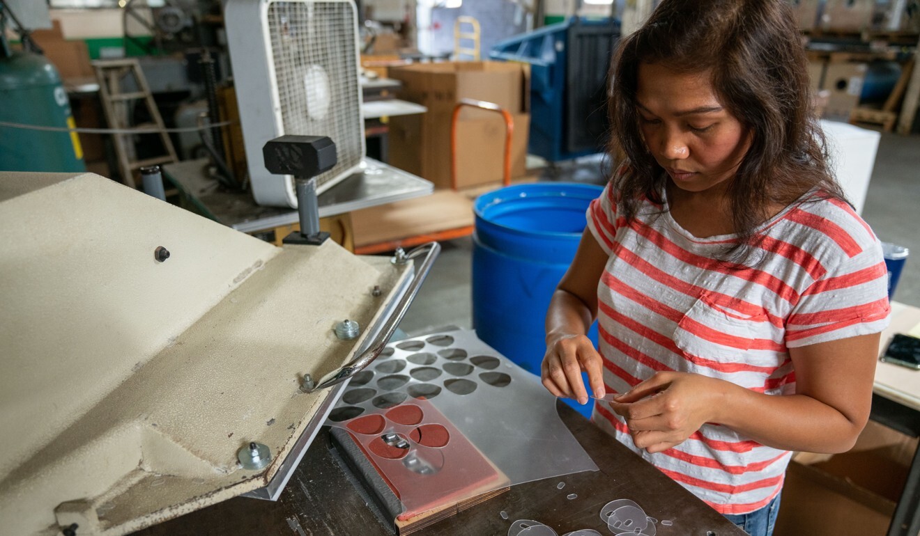A worker removes shields for safety glasses cut from a die cutter at the Team Plastics facility in Cleveland, Ohio, on July 1. The company has said Covid-19-related plastic products now make up 60 per cent of its business. Photo: Bloomberg