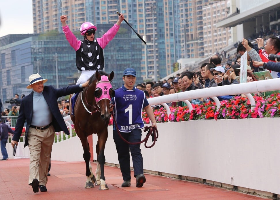 John Moore pats Beauty Generation after his win in the 2019 Queen’s Silver Jubilee Cup, while jockey Zac Purton celebrates.