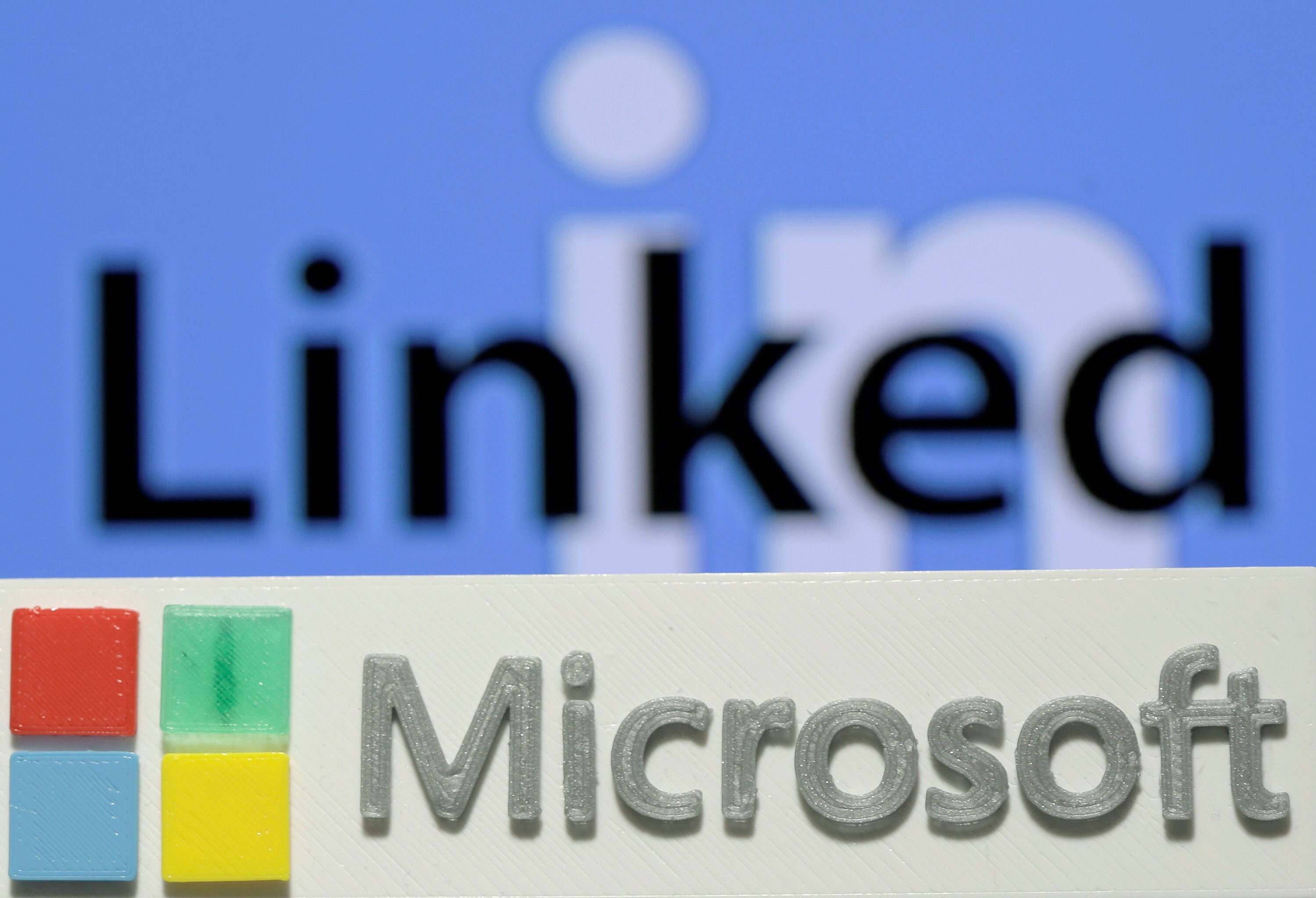 A 3D printed logo for Microsoft is seen in front of a LinkedIn logo. Photo: Reuters