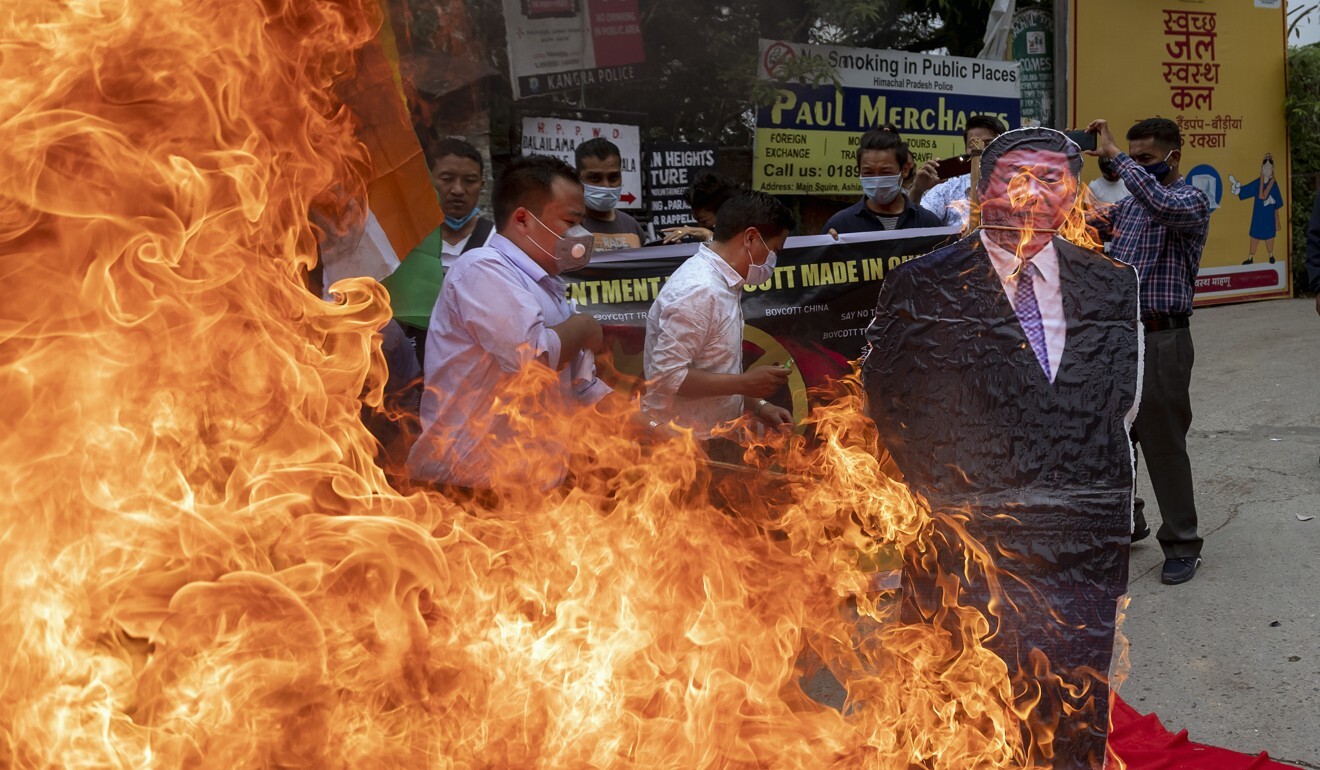 Members of the Tibetan Youth Congress burn a cutout of Chinese President Xi Jinping during a street protest calling for the boycott Chinese goods in Dharmsala. Photo: AP