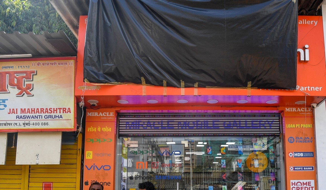 A mobile phone ship in Mumbai, where the name of the Chinese tech firm Xiaomi has been covered with a tarp. Photo: AFP