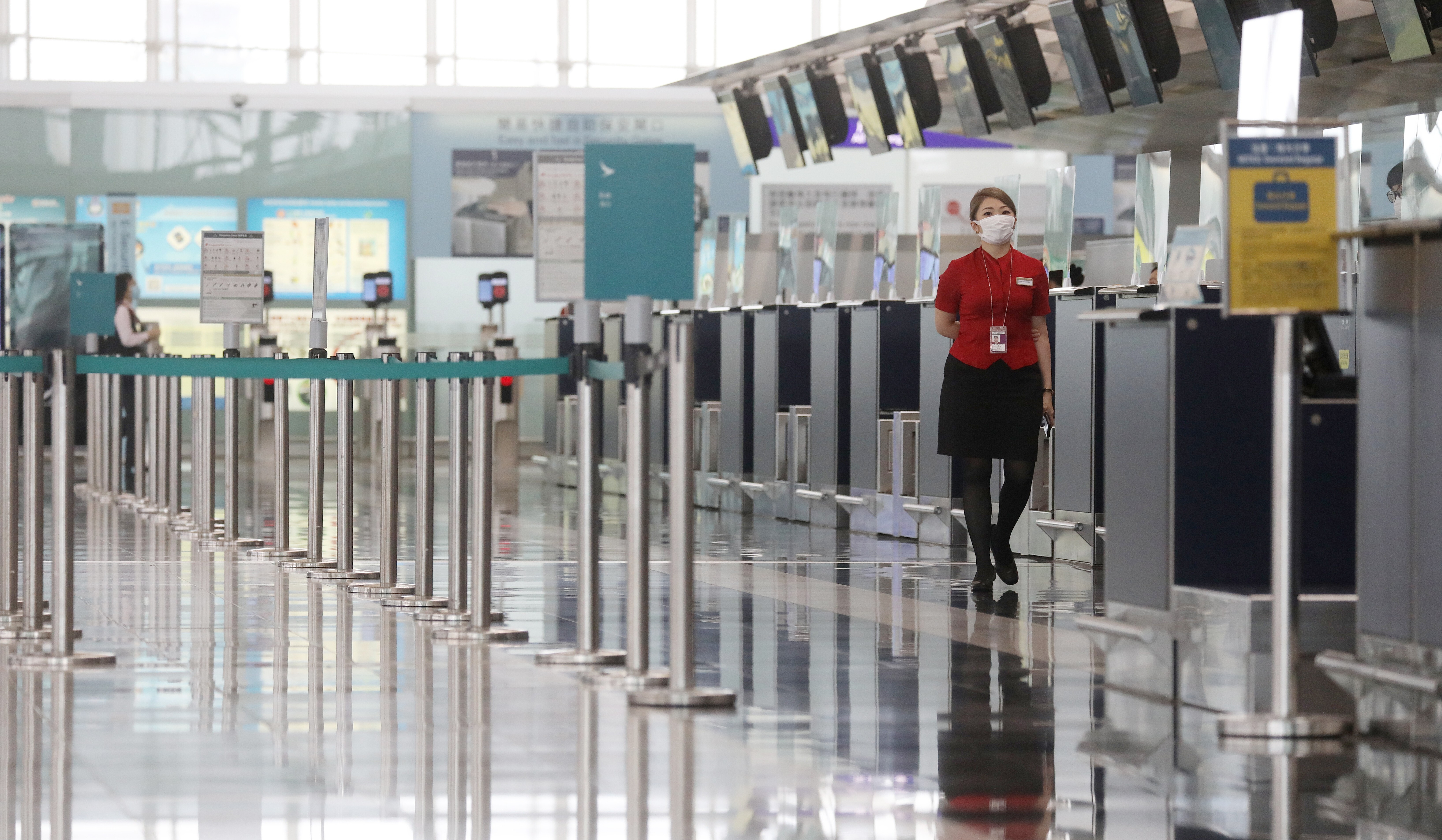 A Cathay Pacific staff member walks past the airlines' check in counter at terminal 1 of the Hong Kong International Airport in Chek Lap Kok in June 2020. The airline industry has continued to suffer from travel restrictions, border closures and quarantine measures to contain the Covid-19 pandemic. Photo: Sam Tsang