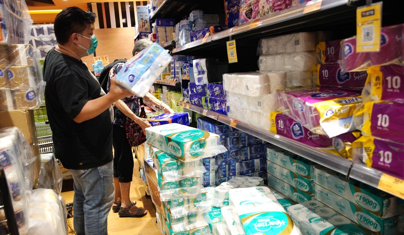 A man buys toilet tissue at a supermarket in Diamond Hill amid the third wave of coronavirus infections on Tuesday. Photo: Winson Wong