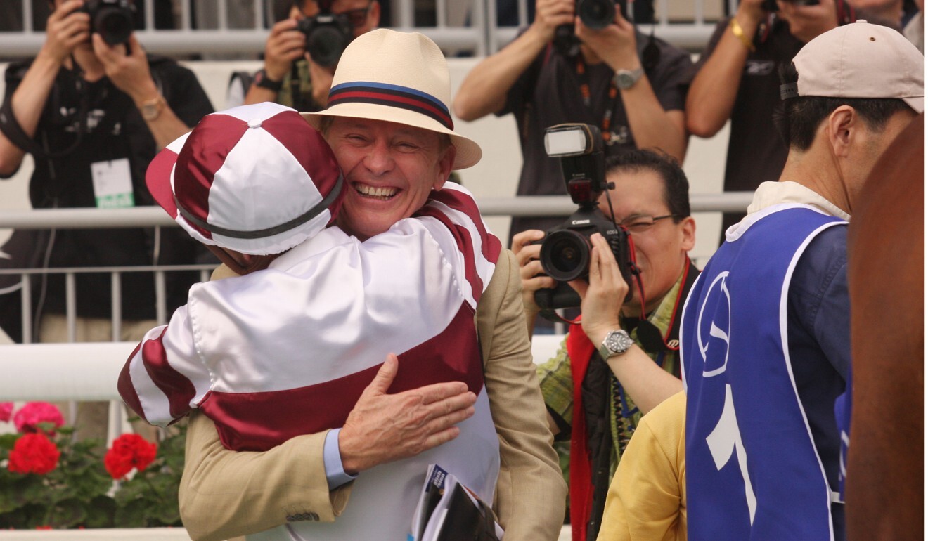 John Moore hugs Darren Beadman after winning the 2009 Hong Kong Derby with Collection. Photo: Kenneth Chan