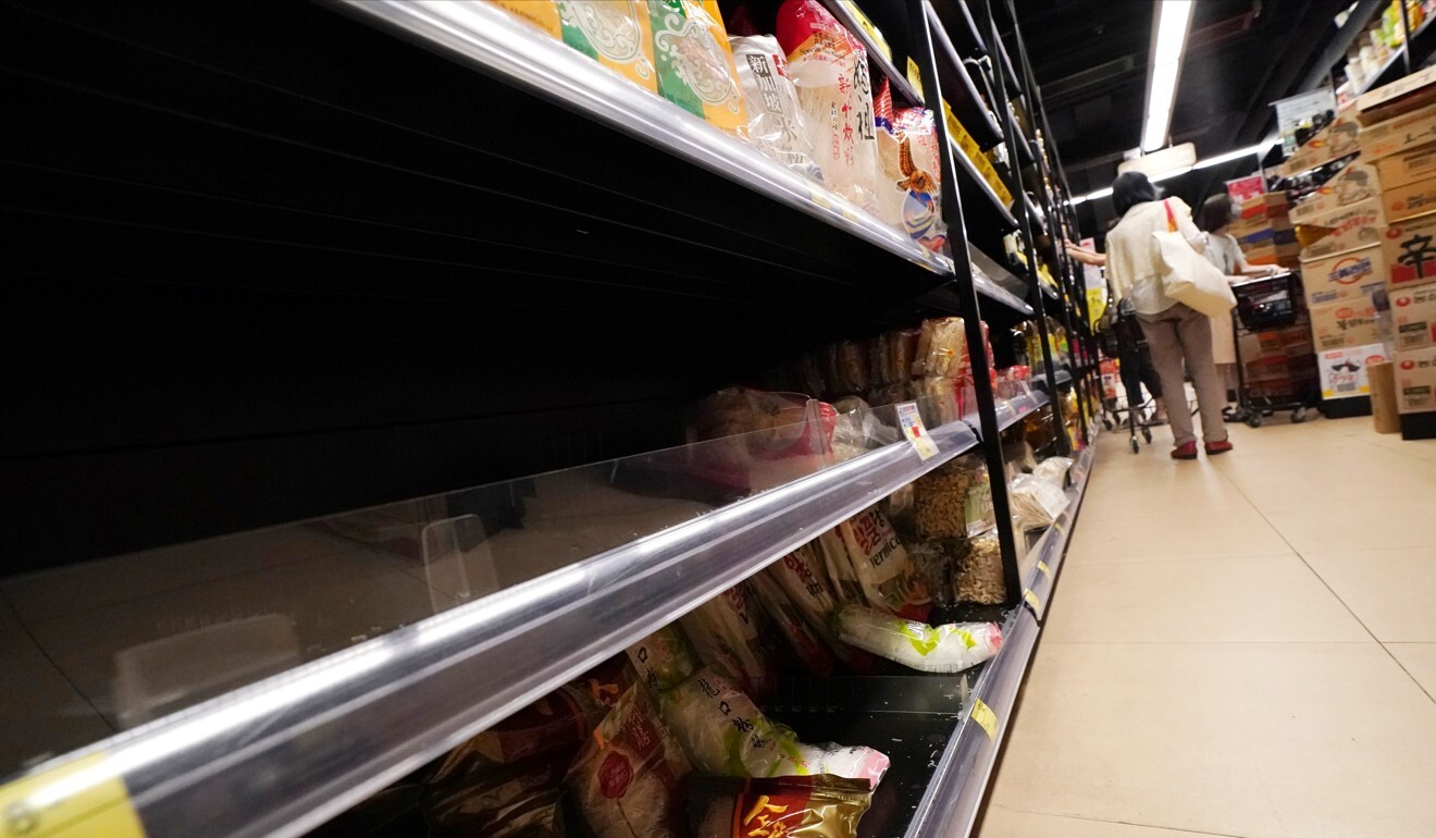 Empty shelves of essential items at a supermarket in Tsz Wan Shan on Tuesday. Photo: Felix Wong