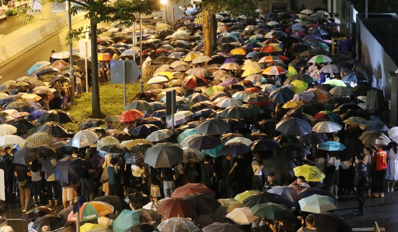 Protesters hold umbrellas outside government headquarters in Admiralty on June 11, a night before the second debate on the extradition bill. Photo: Dickson Lee