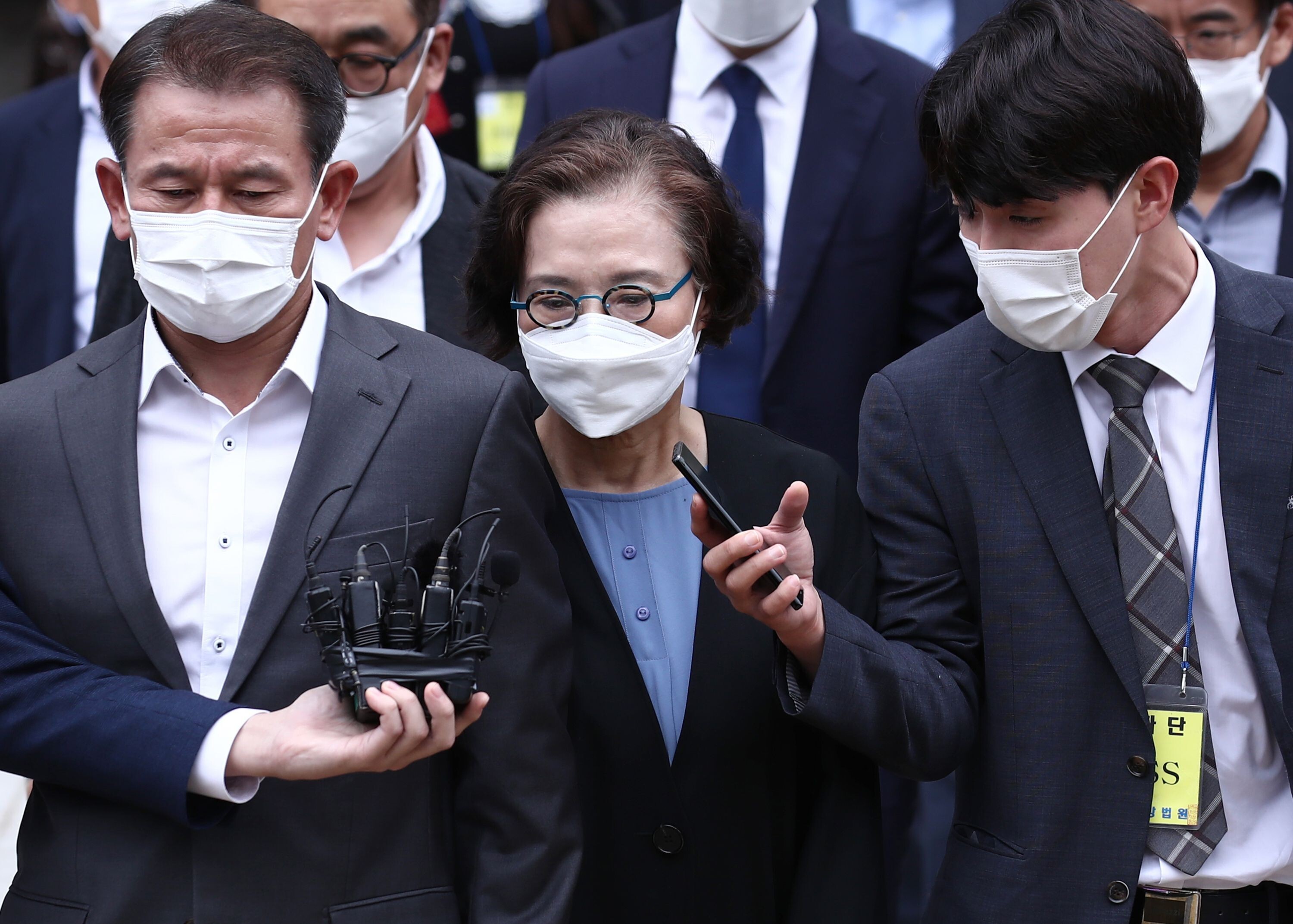 Lee Myung-hee (centre) leaves court after her trial in Seoul. Photo: Yonhap/AFP