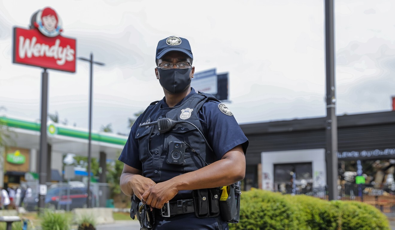 An Atlanta Police Department officer stands watch before the restaurant is demolished. Photo: EPA-EFE