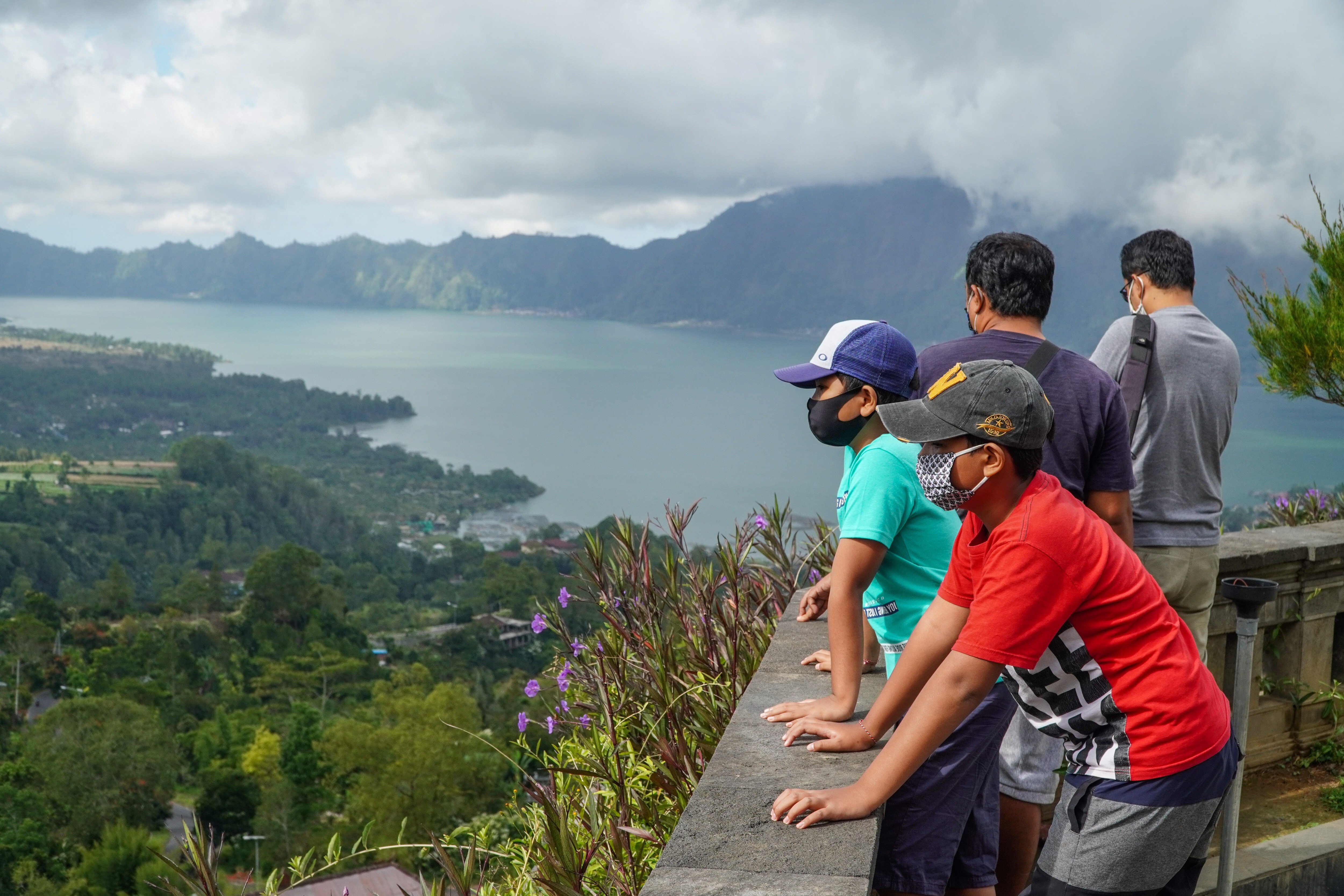 Visitors wearing face masks admire the scenery at Lake Batur in Indonesia. Indonesia’s tourism industry is looking at ways of luring visitors back to the country. Photo: SOPA Images/LightRocket via Getty Images