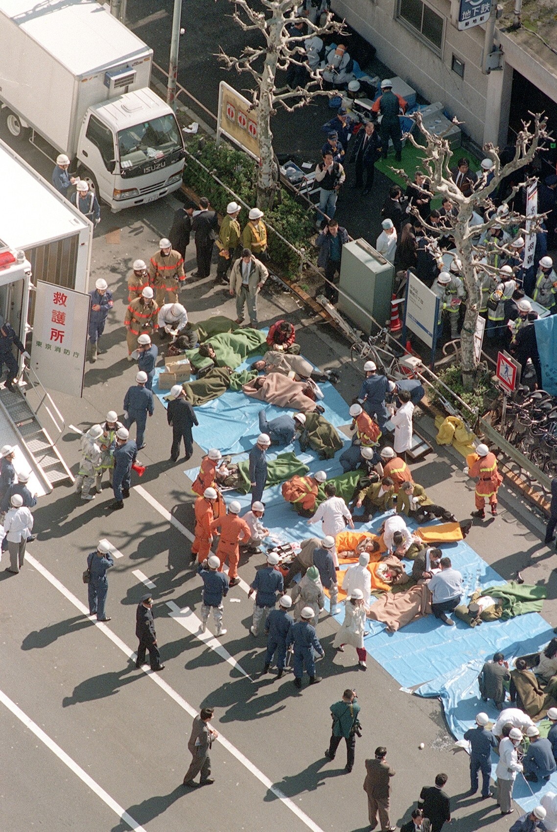 Subway passengers affected by sarin nerve gas are treated near Tsukiji station in Tokyo in this 1995 file photo. Photo: Kyodo News via AP