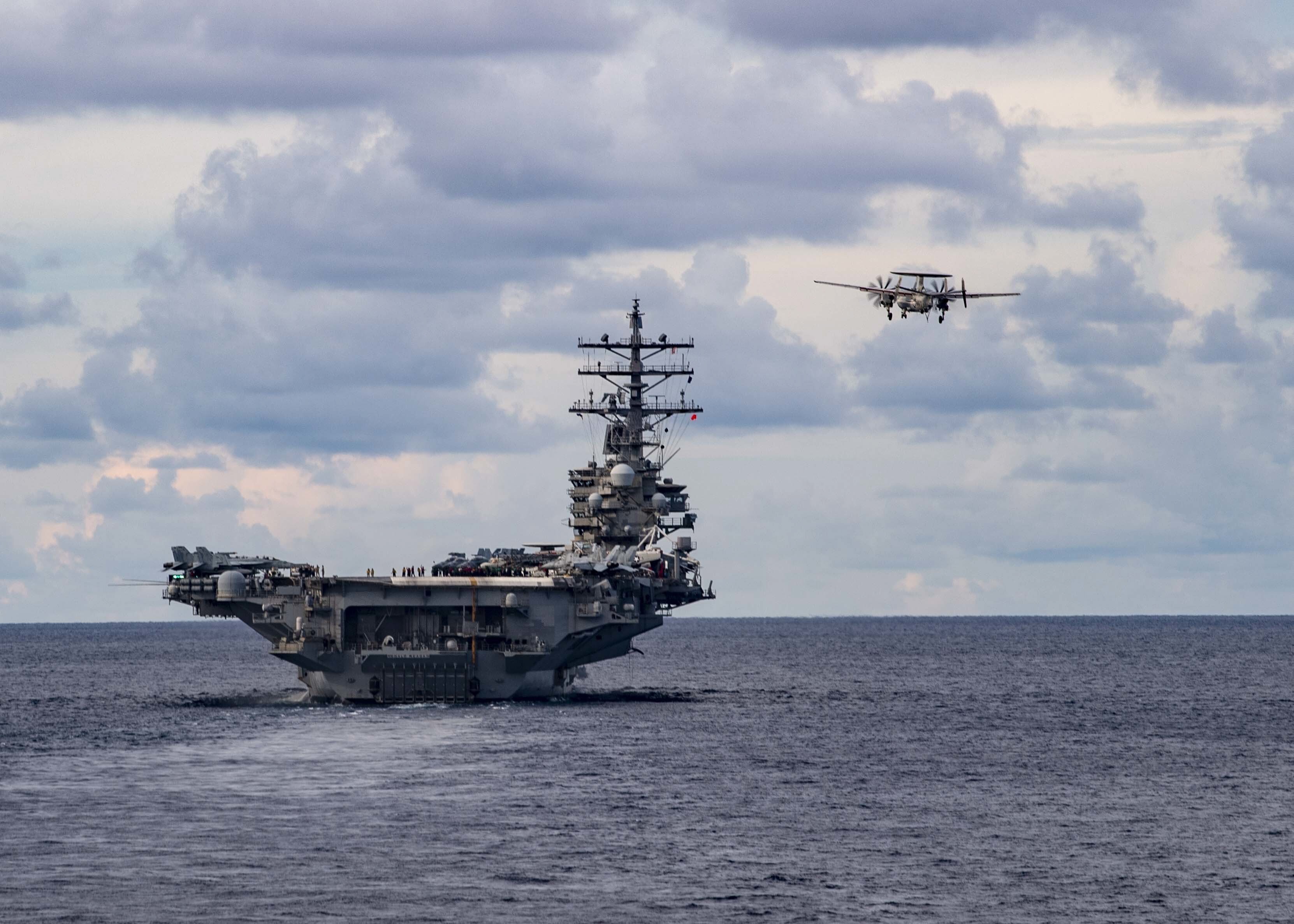 A US surveillance plane flies past the USS Ronald Reagan aircraft carrier during a drill in the South China Sea earlier this month. Photo: EPA
