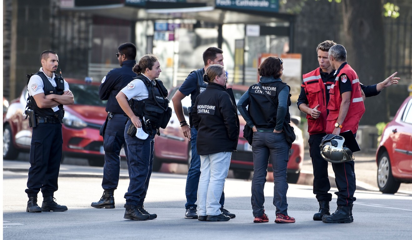 Firefighters and forensic investigators are seen in front of the cathedral in Nantes after a fire on Saturday. Photo: AFP