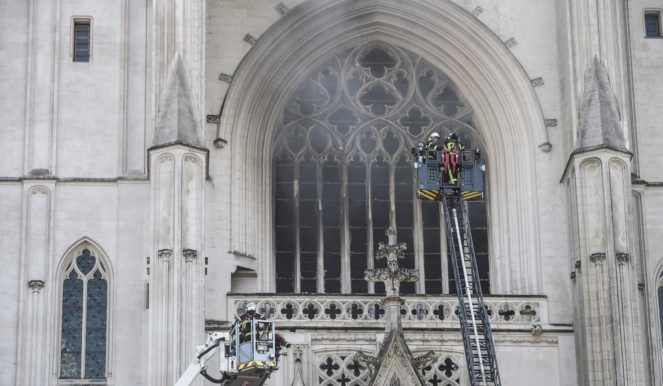 Firefighters extinguish a fire that broke out at the Nantes cathedral on July 18. Photo: DPA
