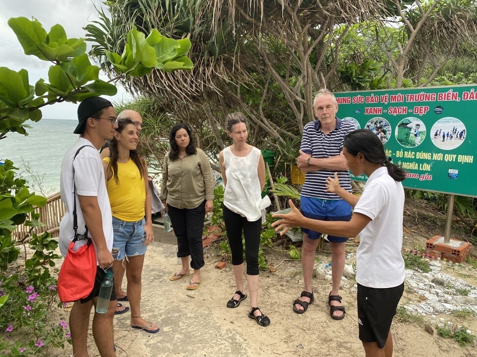 Huong Pham (right) explains sea turtle nesting to the tour group. Photo: Patrick Scott