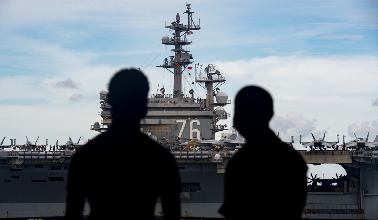 Sailors on board the USS Nimitz observe the USS Ronald Reagan during dual aircraft carrier operations in the South China Sea on July 6. Photo: EPA-EFE