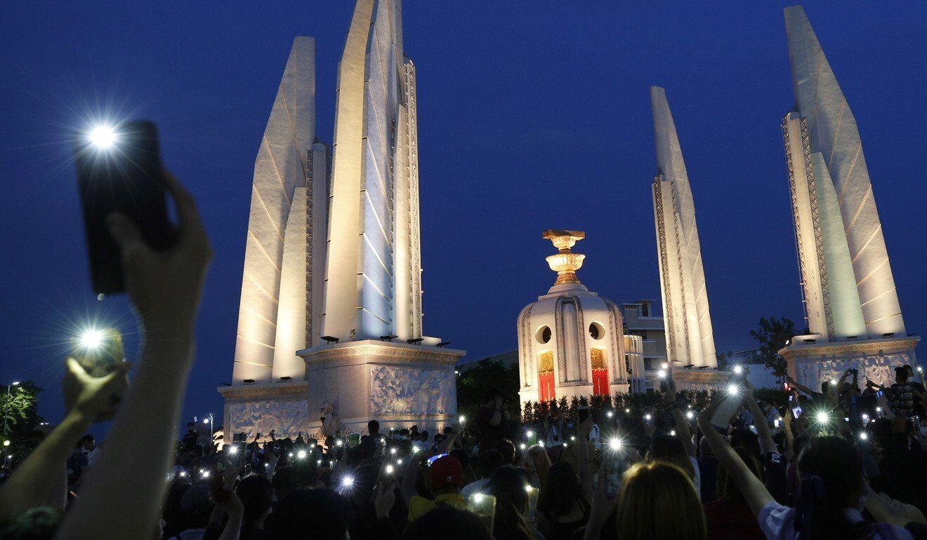 Protesters display the flashlights on their cellphones at a rally near the Democracy Monument in downtown Bangkok. Photo: EPA