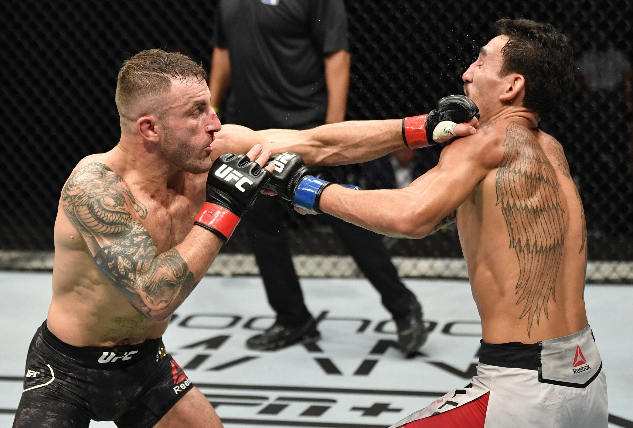 Alexander Volkanovski punches Max Holloway in their featherweight championship fight during UFC 251 at Flash Forum on UFC Fight Island in Abu Dhabi. Photo: Jeff Bottari/Zuffa LLC