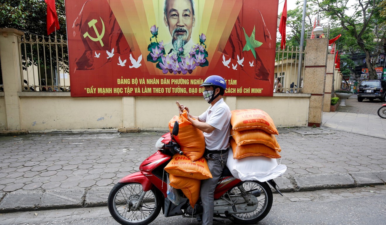 A man carries rice bags to distribute to poor people affected by coronavirus restrictions, in Hanoi. Photo: Reuters