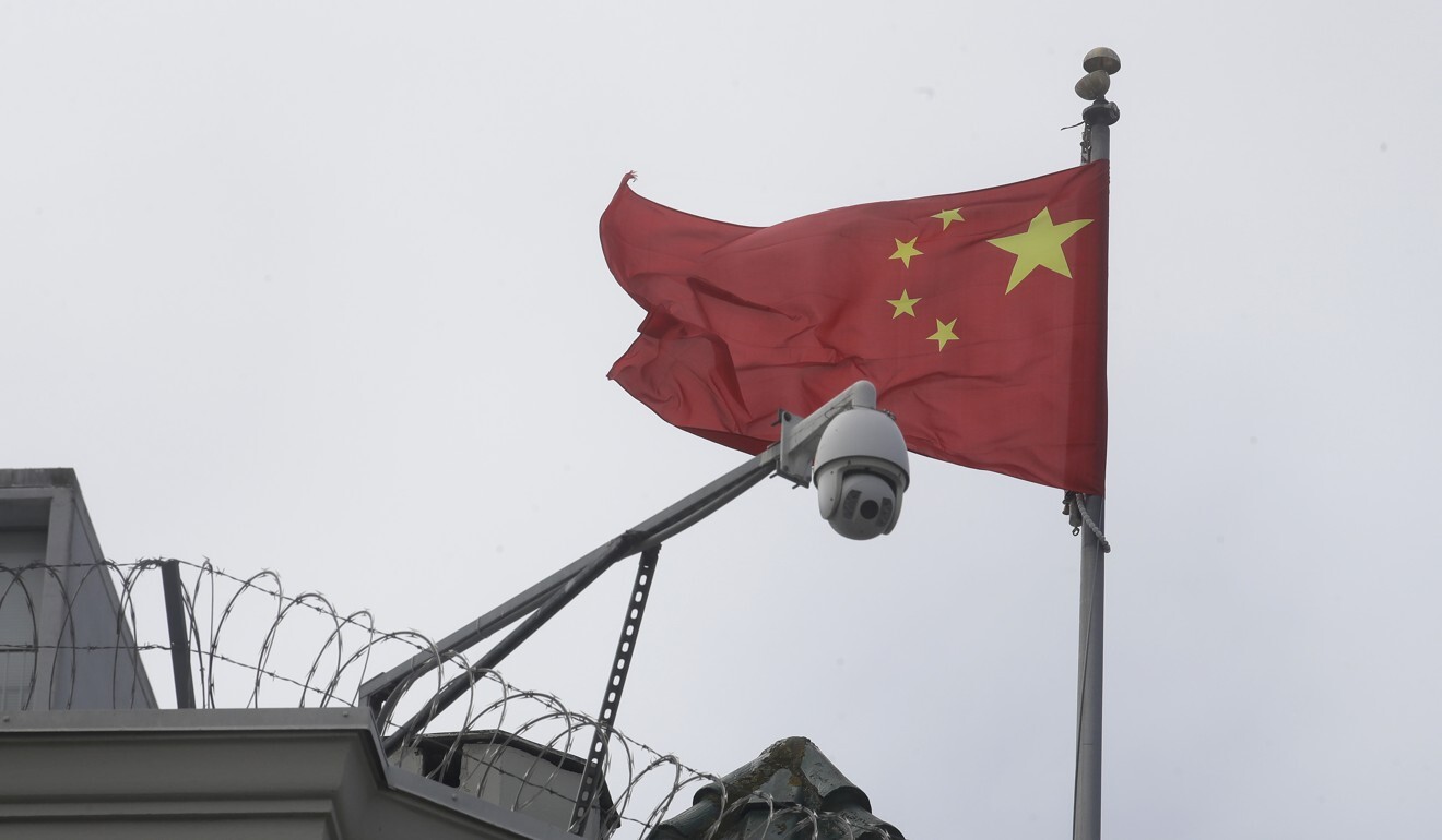 The Chinese flag flies behind a security camera at a Chinese consulate in the US. Photo: AP