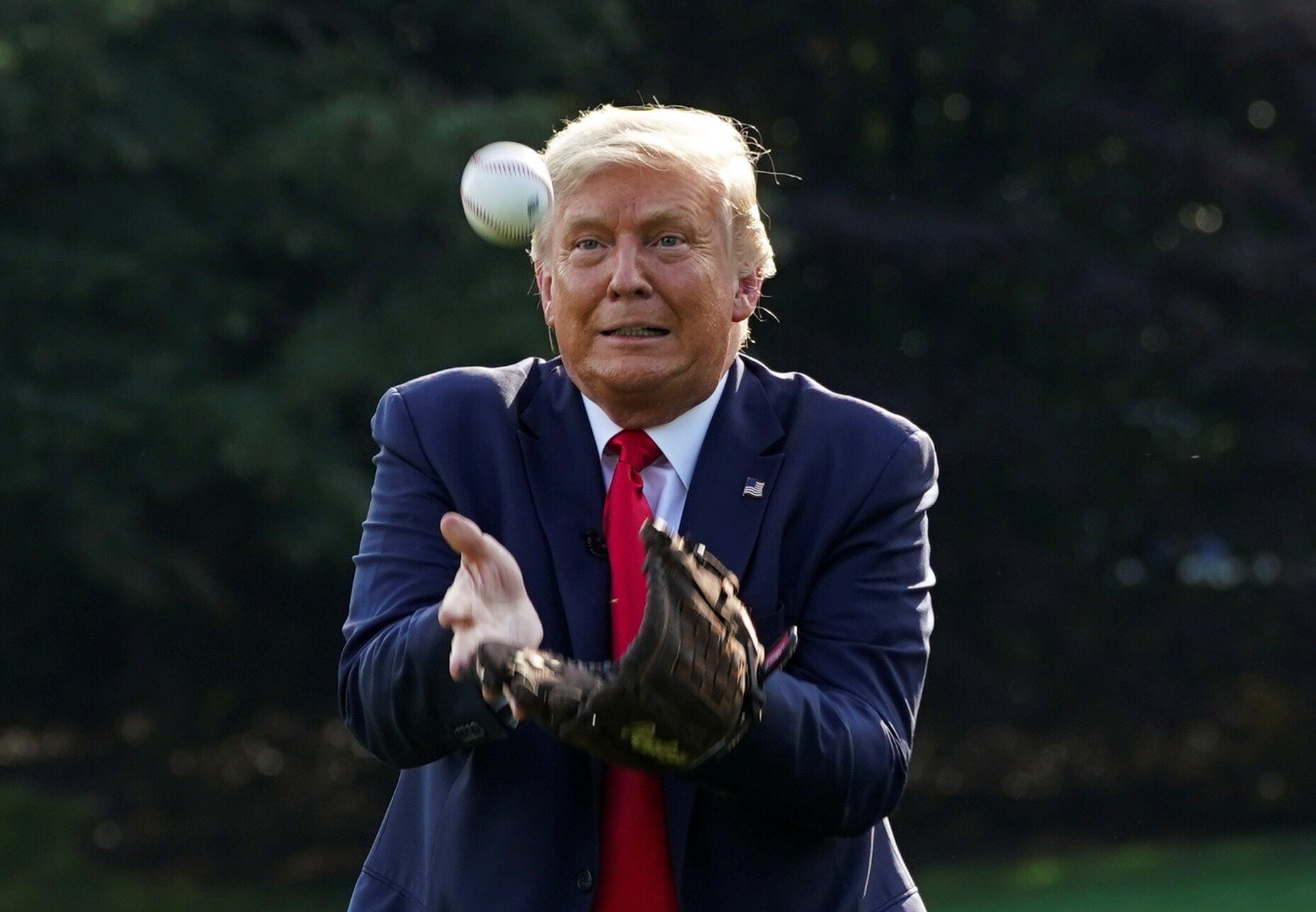 US President Donald Trump catches a ball while hosting young baseball players at the White House. Photo: Reuters