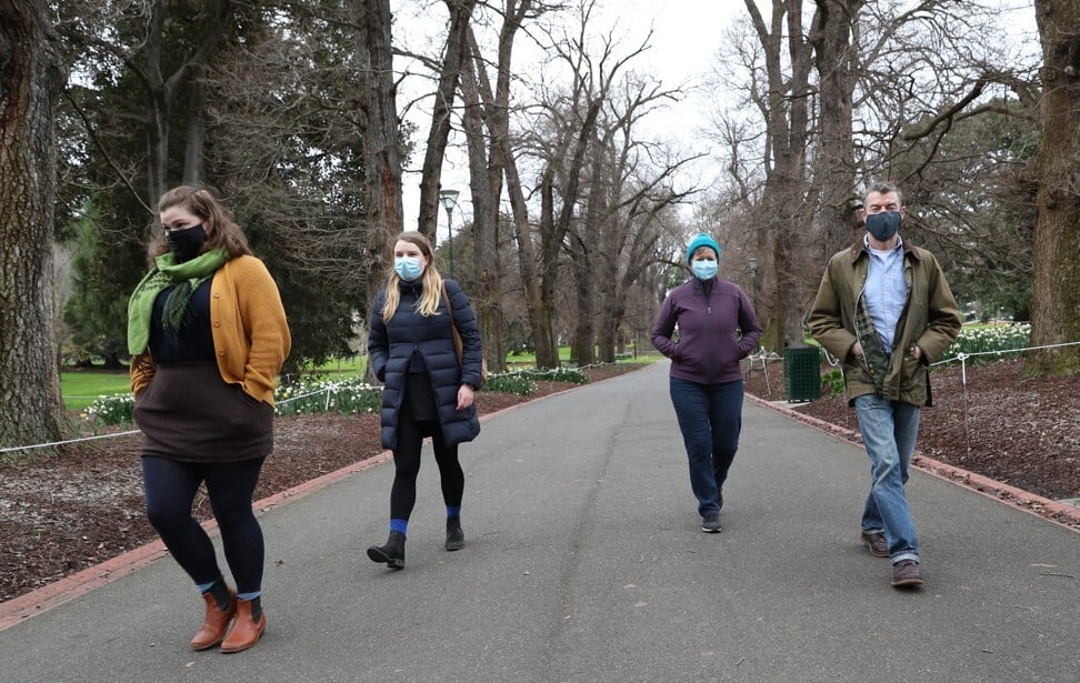 People in Melbourne wear face masks as they take a walk on July 18, 2020. Photo: EPA