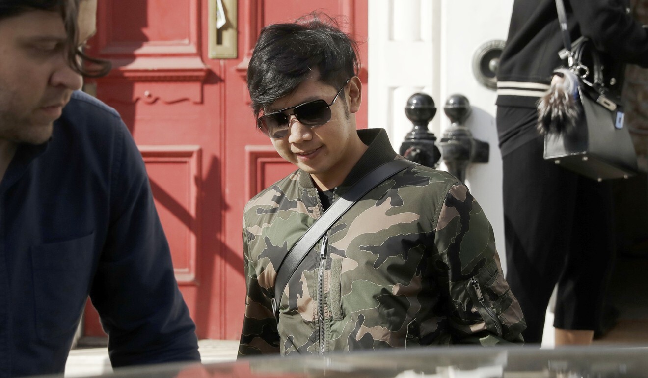 Vorayuth “Boss” Yoovidhya leaves a house in London in April 2017. The Red Bull heir has been leading a jet-setting life in exile. Photo: AP
