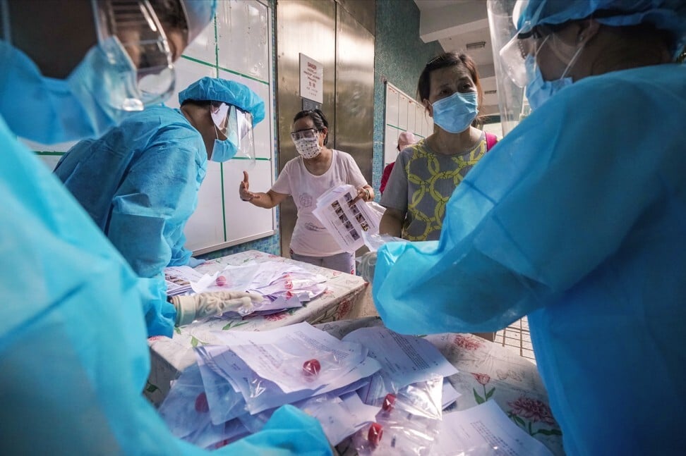 Residents of Tsz Ching Estate in Tsz Wan Shan receive Covid-19 testing kits during Hong Kong’s third wave of infectons. Photo: Felix Wong