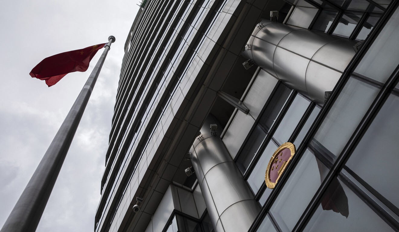 The Chinese flag and emblem are displayed outside the Office for Safeguarding National Security in Hong Kong, temporarily set up at the Metropark Hotel in Causeway Bay, shortly after the adoption of the new national security law. Photo: Bloomberg