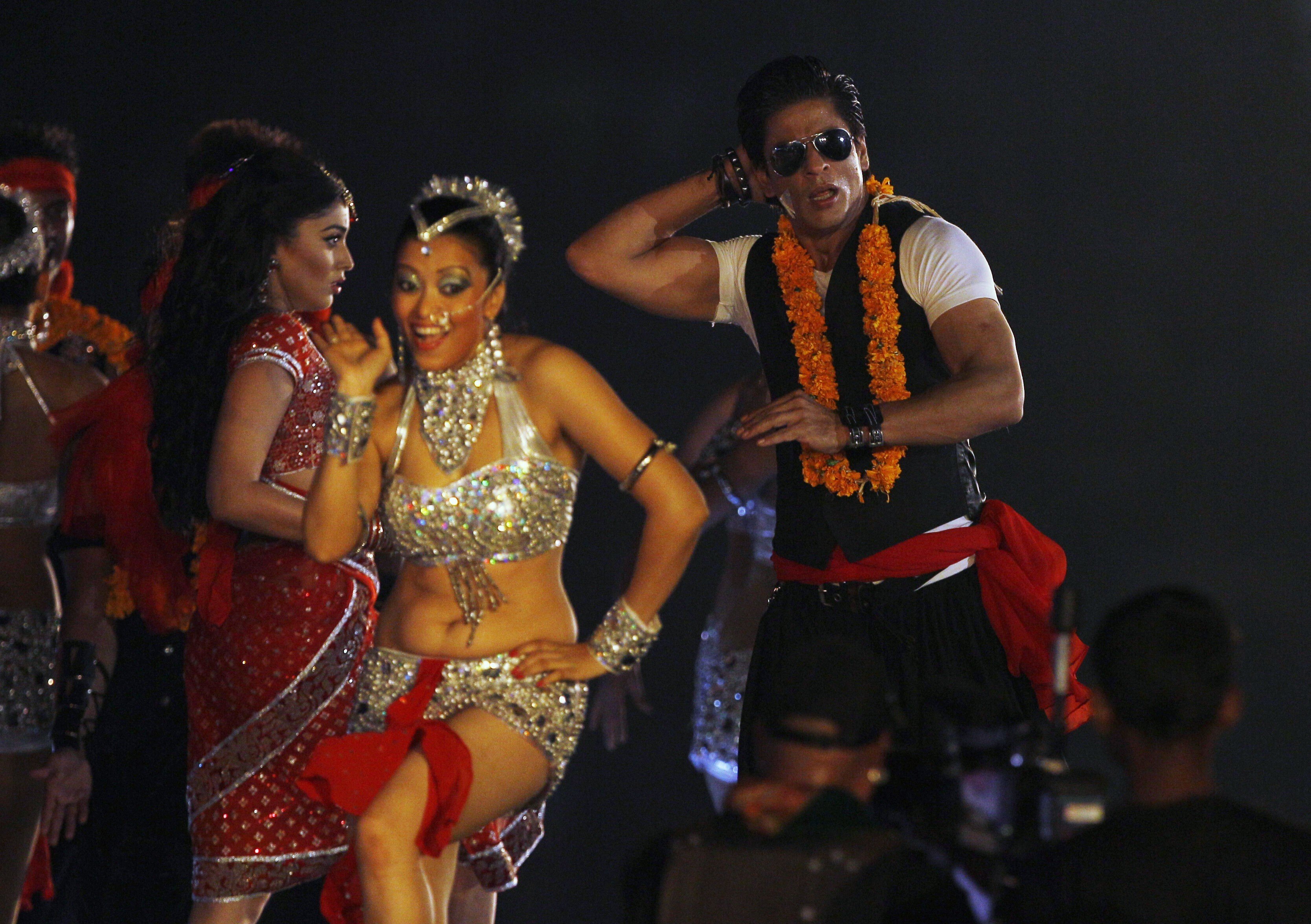 Bollywood and the Indian Premier League are intertwined. Actor Shahrukh Khan (right) performs during an opening ceremony in Chennai. Photo: AP