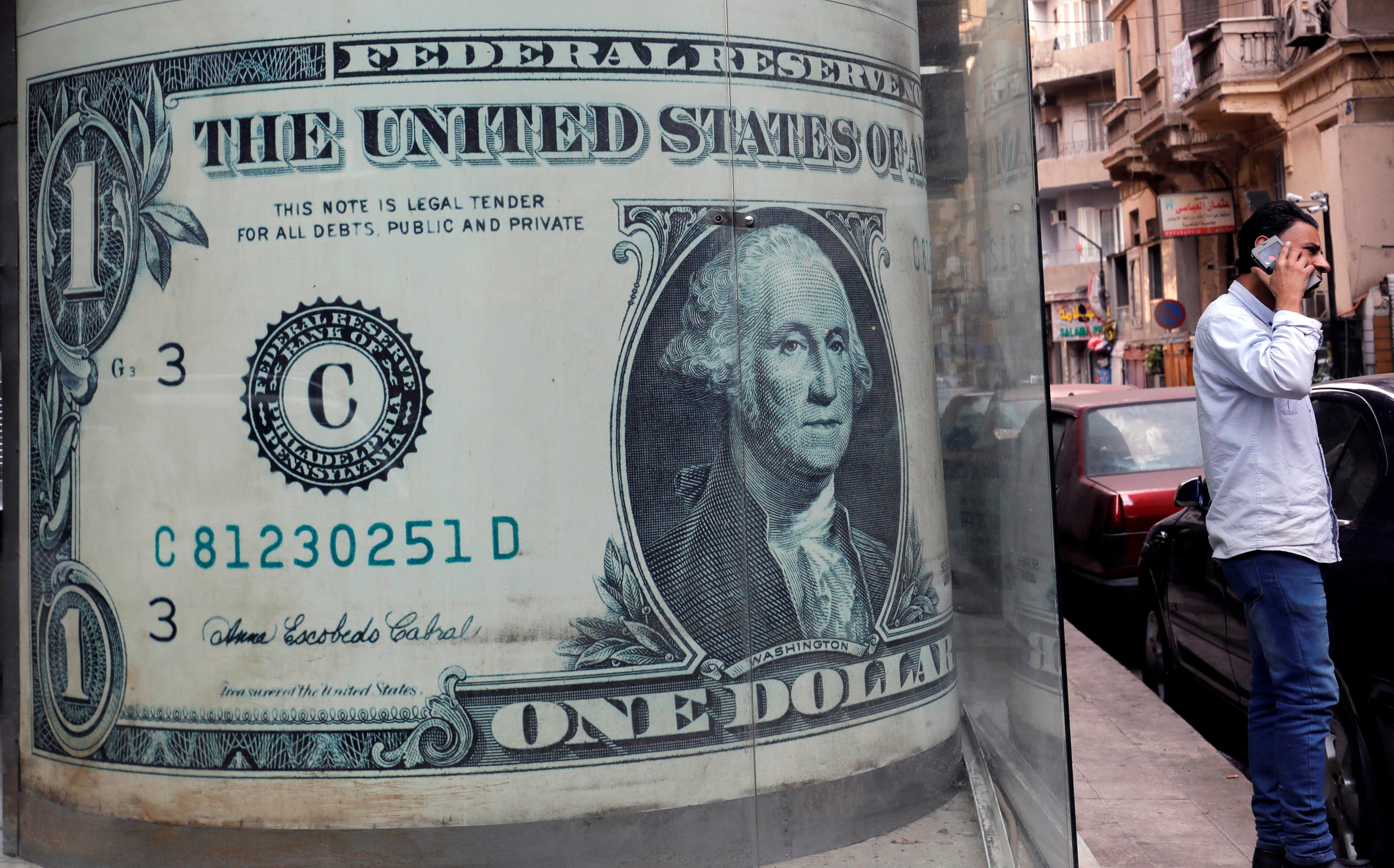 An image of a US dollar bill at a currency exchange bureau in Cairo. The dollar is losing its lustre against gold, silver and other key currencies. Photo: Reuters