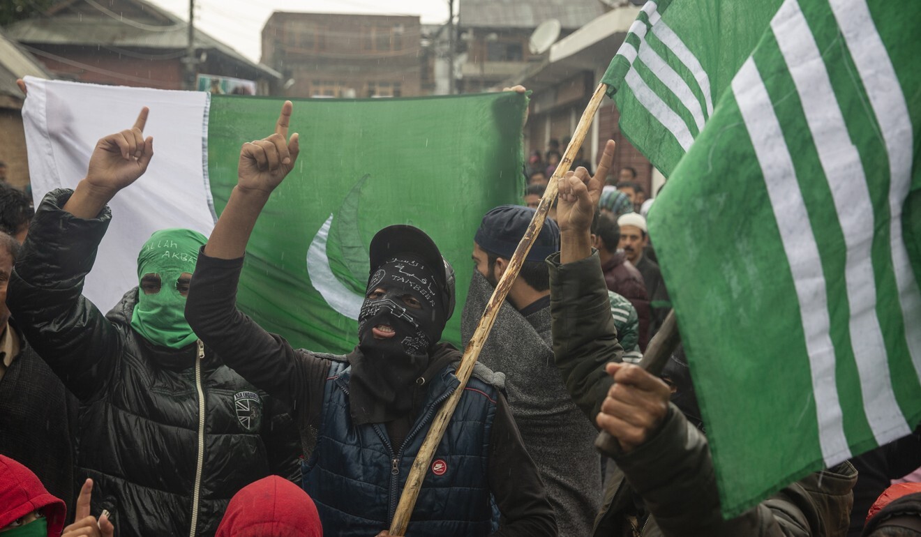 Masked Kashmiris shout slogans during a protest after Friday prayers on the outskirts of Srinagar in October 2019. Photo: AP