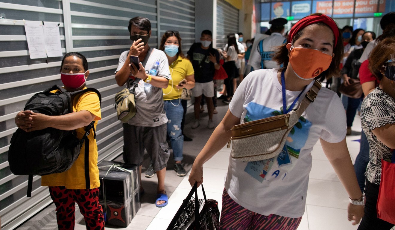 Filipinos queue for buses going to nearby provinces a day before Manila goes back to a stricter lockdown amid rise in coronavirus infections. Photo: Reuters