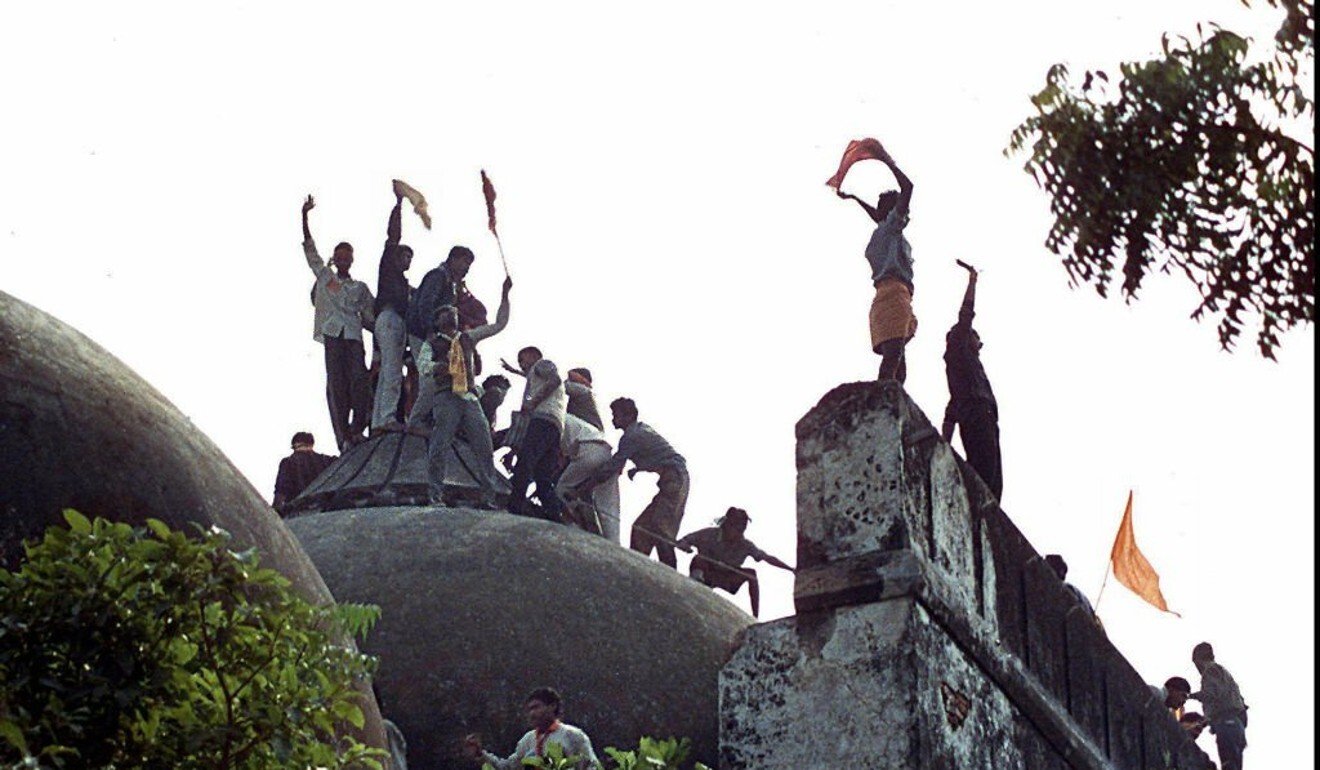 Hindu youths clamour atop the 16th-century Babri Mosque in 1992, hours before the structure was completely demolished. Photo: AFP