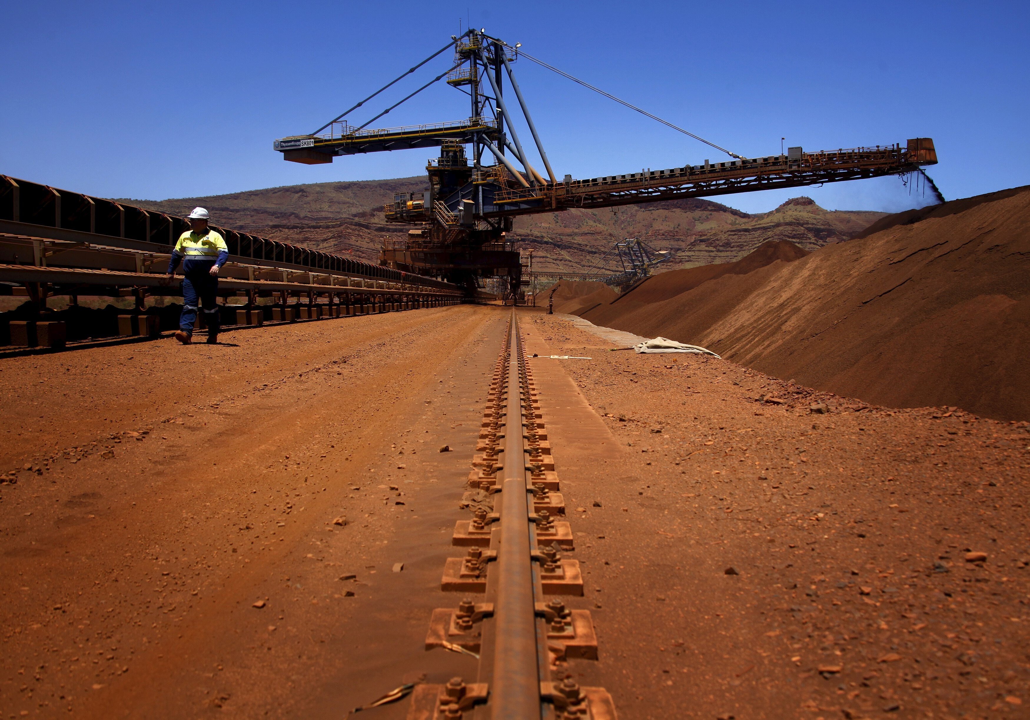 A mine worker inspects conveyor belts transporting iron ore at Fortescue’s Solomon iron ore mine in Sheila Valley, Australia. Photo: Reuters