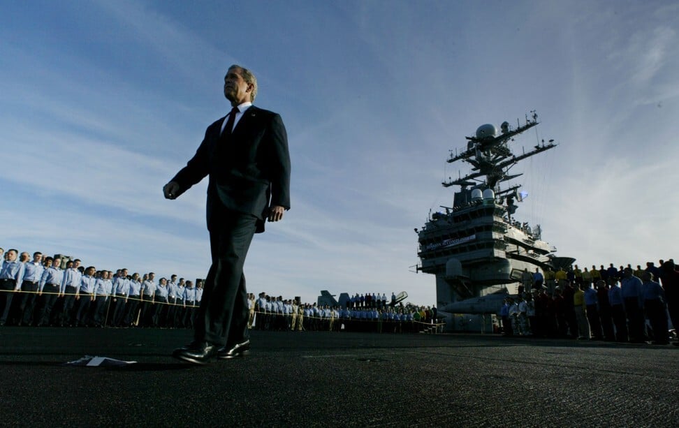 Then-US President George W. Bush passes crew members as he walks the deck of the aircraft carrier USS Abraham Lincoln in 2003. Bush launched a ruinous war in Iraq based primarily on many intelligence failures. Photo: Reuters