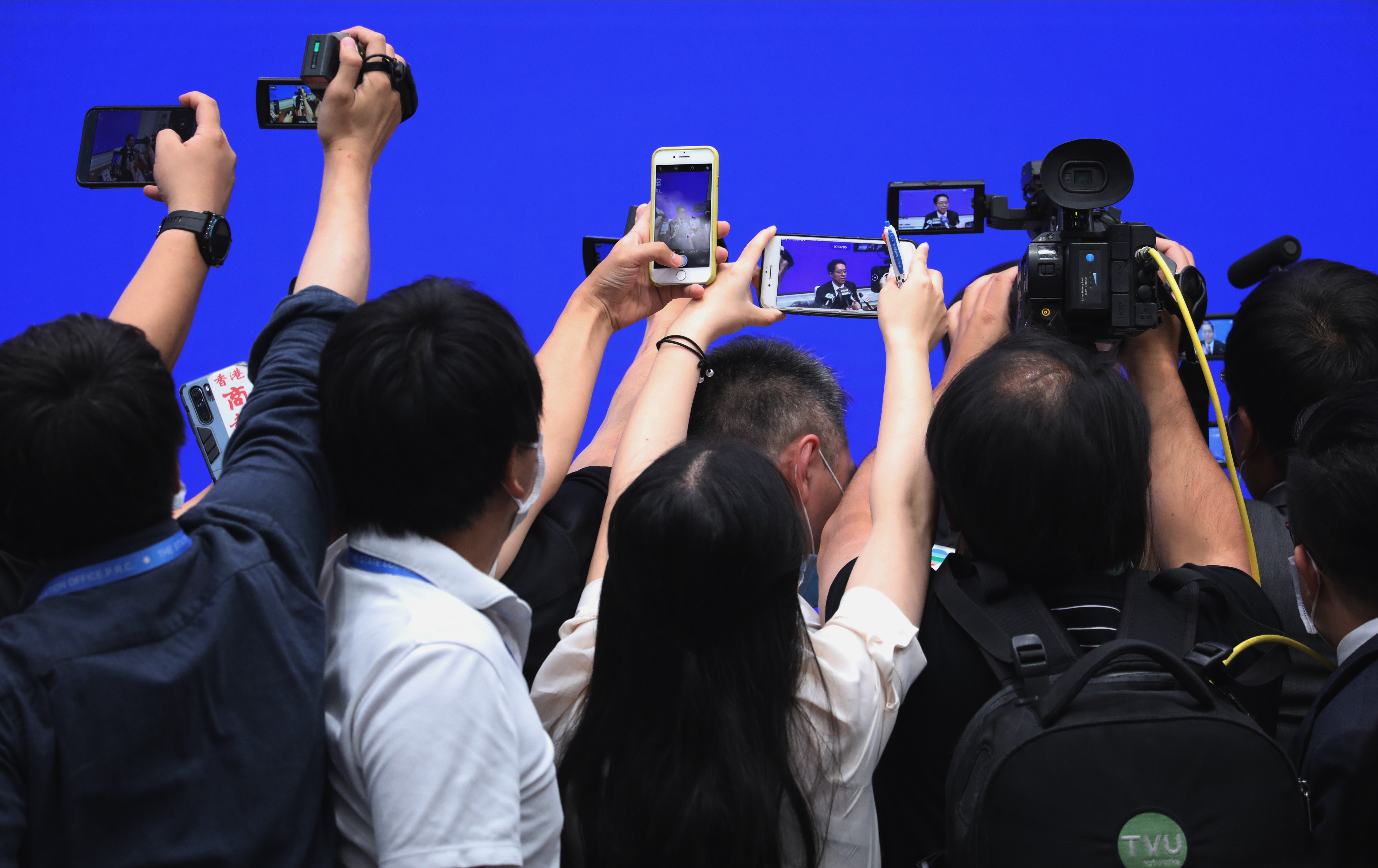 Members of the press take photos of Zhang Xiaoming, deputy director of the State Council’s Hong Kong and Macau Affairs Office, at a media conference in Beijing on July 1. Why was Zhang’s visit to Hong Kong to hear views on extending the term of Hong Kong’s current legislature shrouded in secrecy? Photo: Simon Song