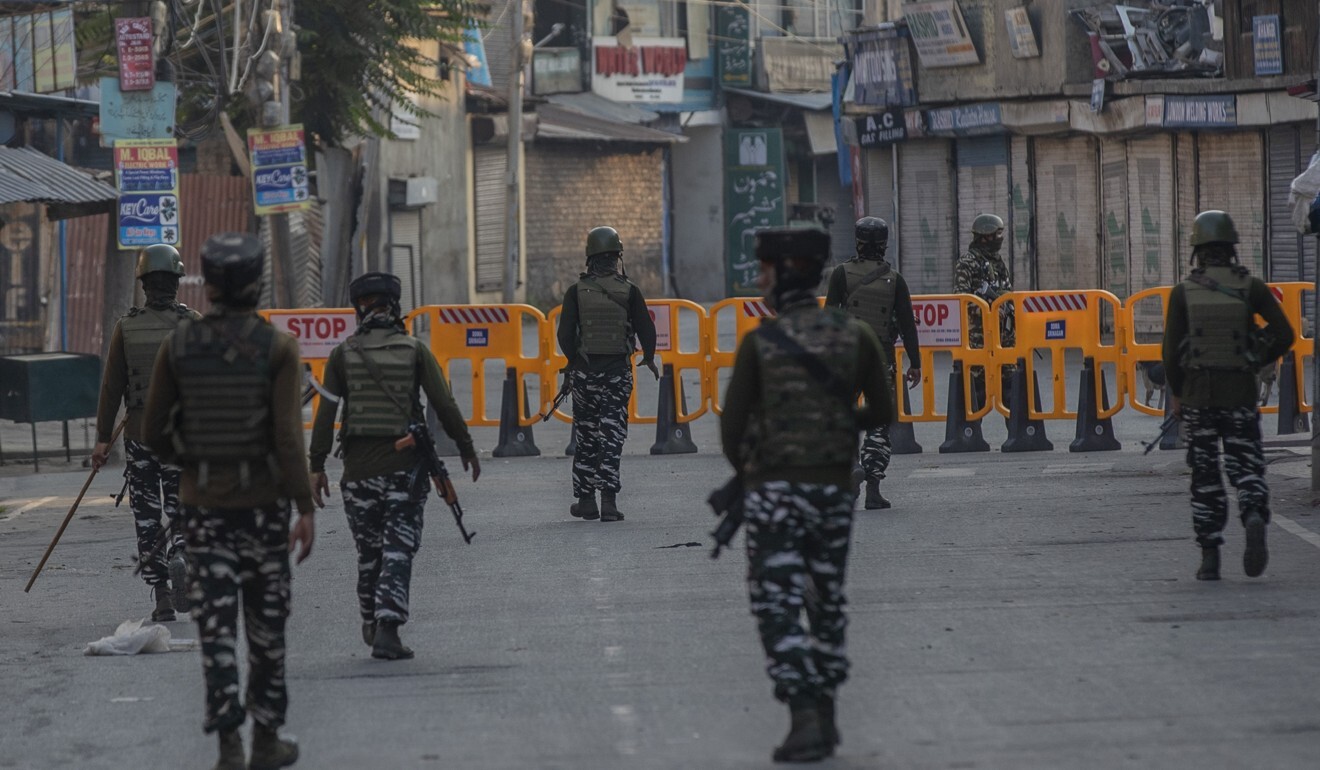 Paramilitary soldiers patrol a deserted street in Srinagar, Indian-administered Kashmir, on the first anniversary of the decision to revoke the region’s semi-autonomy. Photo: AP