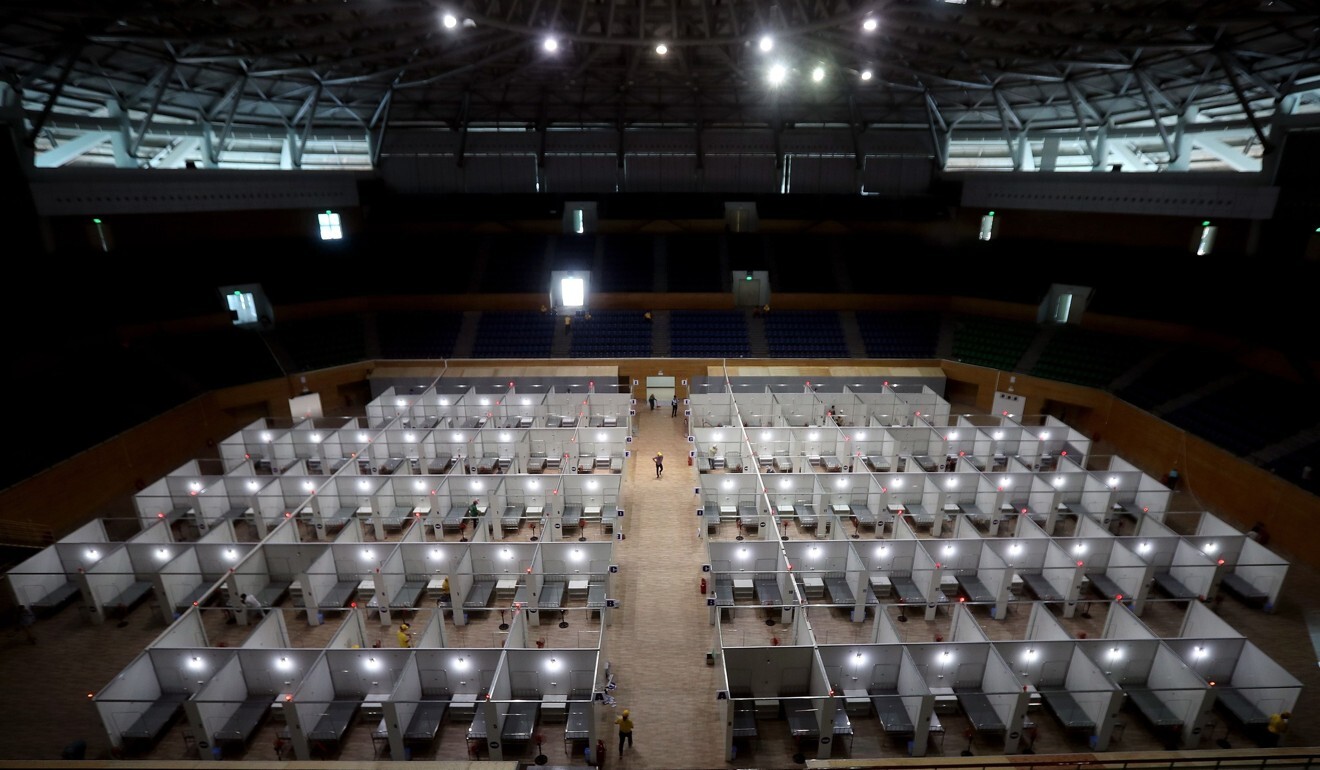 Workers prepare a makeshift field hospital inside the Tien Son sports complex in Da Nang. Photo: AFP
