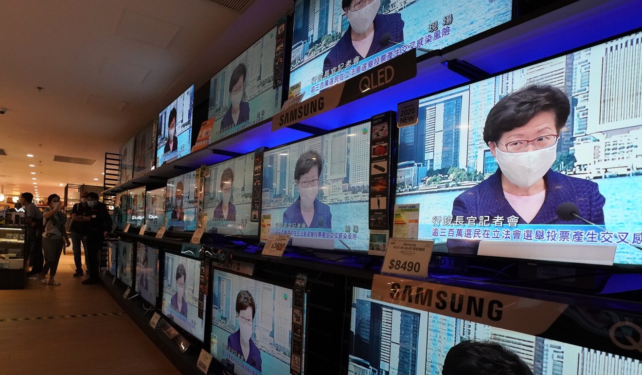 Televisions at a store play a live broadcast of Hong Kong Chief Executive Carrie Lam invoking emergency powers to postpone the Legco elections. Photo: Felix Wong