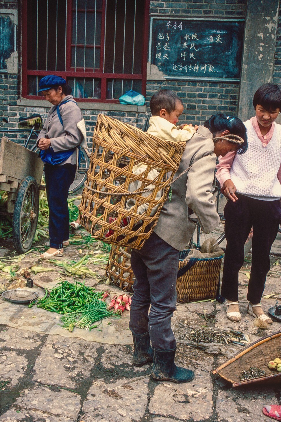 A baby in a basket in Lijiang Old Town, Yunnan province, 1995. Photo: Bruce Connolly