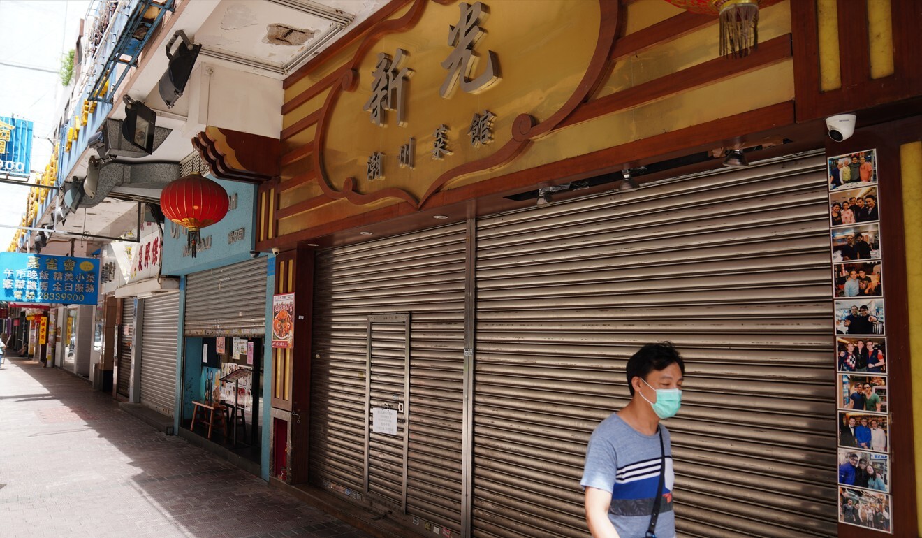 A man passes a closed restaurant in Wan Chai amid the third wave of coronavirus infections. Some academics think Hong Kong’s handling of the pandemic will put off international students. Photo: Sam Tsang