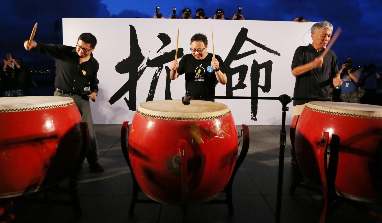 Occupy Central co-founders (from left) Chan Kin-man, Benny Tai Yiu-ting and Reverend Chu Yiu-ming beat on drums during a protest rally at Tamar Park on August 31, 2014. Photo: Felix Wong