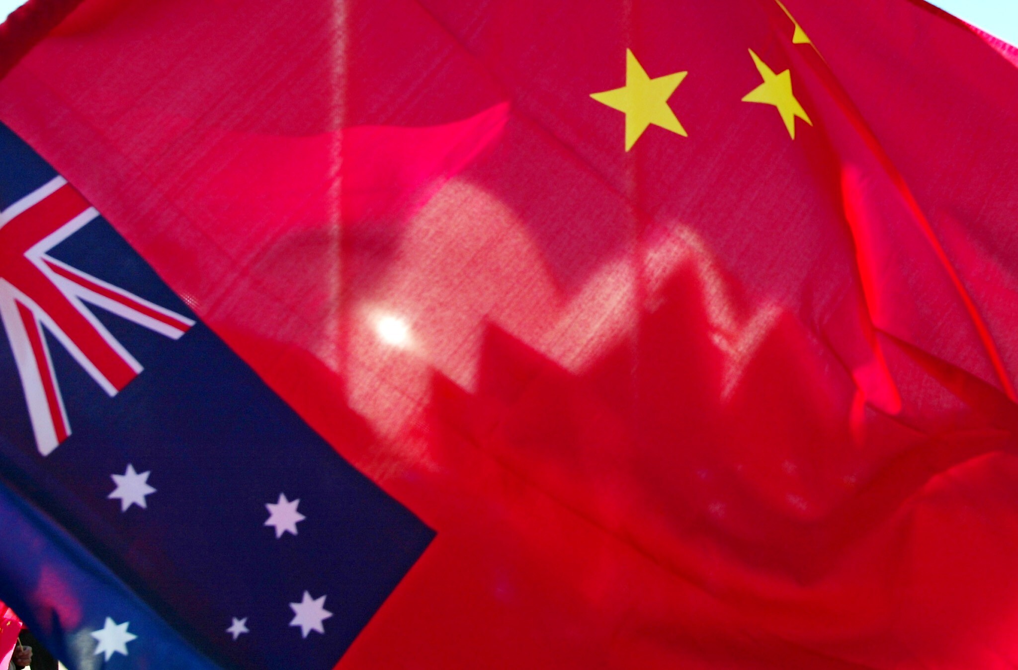 The Sydney Opera House is seen through a Chinese flag. Understandably, where some of China’s activities are not in line with Australian values, they attract criticism. But does that mean Australia should throw away its economic security? Photo: AFP